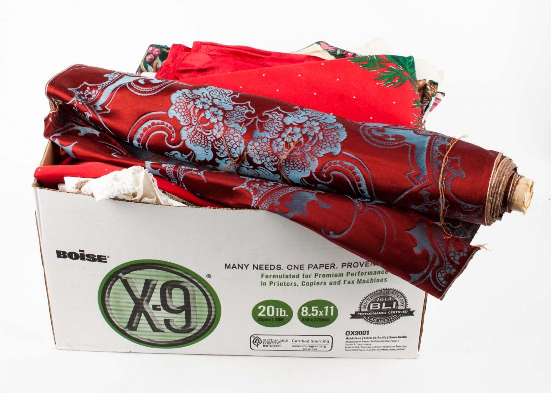 Assorted fabric and table settings: assorted pieces of fabric along with place mats, tablecloths, and 1 bolster of red and blue fabric that appears to have never been used