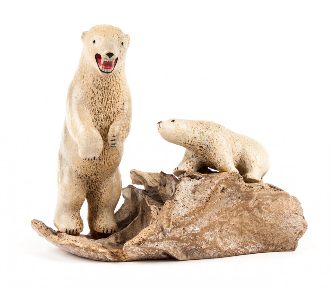 Inuit carved bone polar bear group: modeled as carved bone mother and cub polar bears mounted on natural bone base, 7 1/2 in. H., 9 in. W.