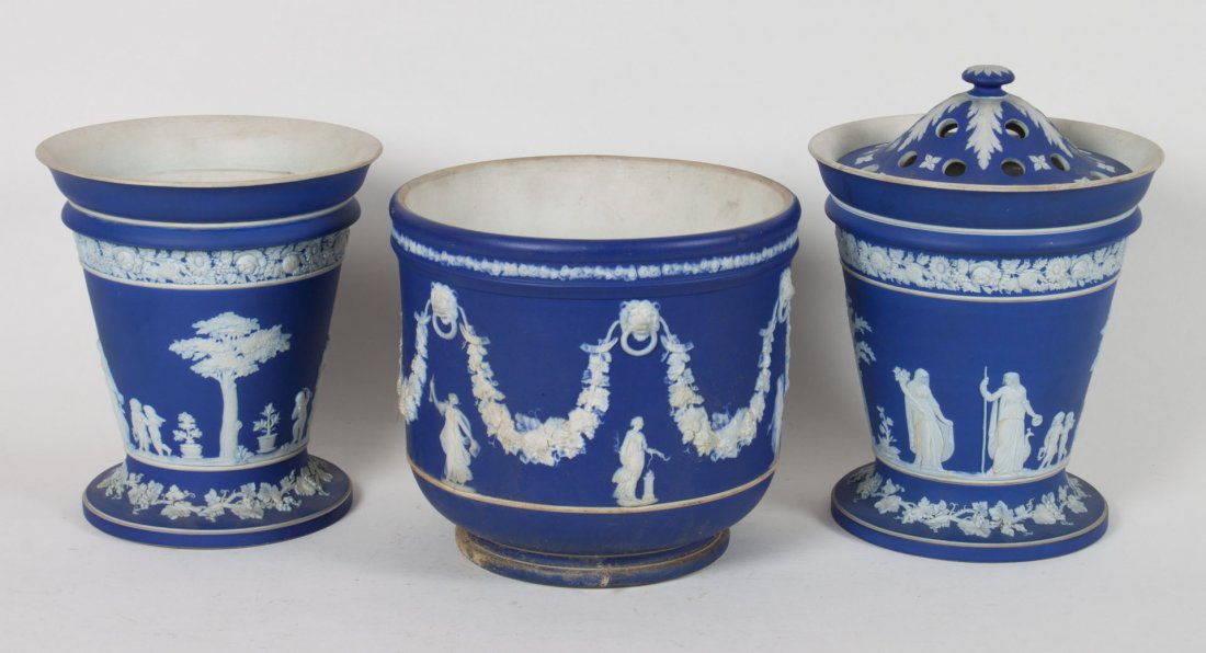 Pair of Wedgwood jasperware bough pots & cachepot: second quarter-19th century; each with blue ground and white relief decoration, all impressed 'WEDGWOOD," bough pots - 7 1/2 in H., 7 in. Diam., without lids, cachepot - 7 in. H., 8 in. Diam.