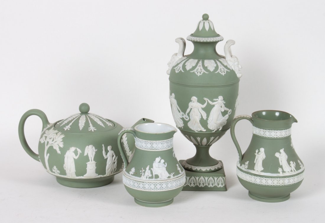 Four Wedgwood jasperware articles: 20th century; sage green ground with white relief decoration, including: covered urn, teapot, and two cream jugs, 4 1/2 to 10 1/2 in. H.