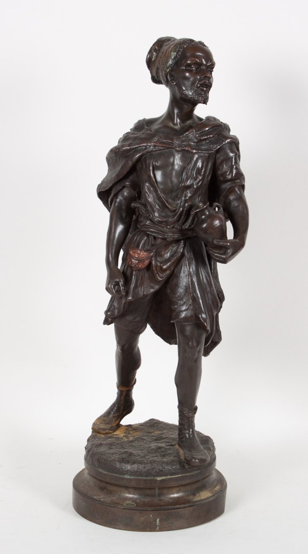 French School, 19th c. Arab bronze: painted bronze of Arabian male figure carrying a jug, 22 in. H.