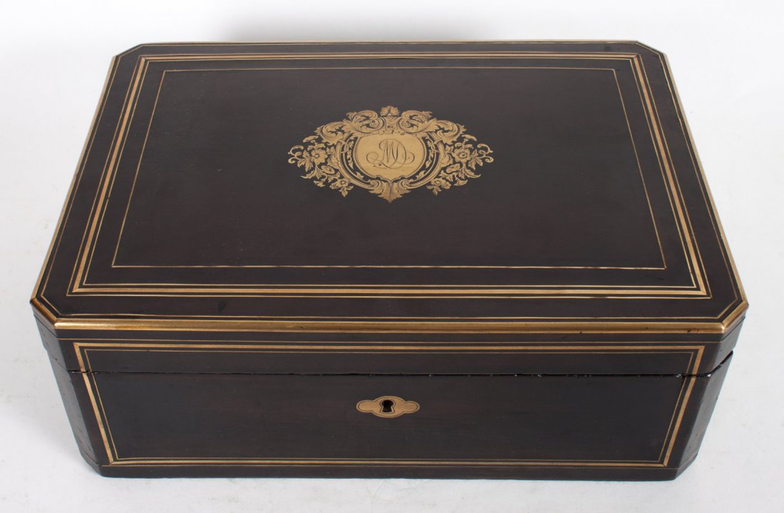 Edwardian brass inlaid wood box: early 20th century; inlaid brass shield with monogram, removable sectional tray, lock stamped "Tahan Fab," 5 in., 13 in. W., 9 in. D.