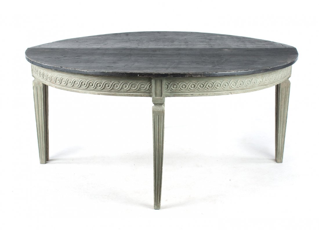 Pair of French painted console tables: 19th century; Neoclassical style, half-round form with guilloche carved apron and three squared fluted legs, 31 1/2 in. H., 70 in. W., 31 1/2 in. D.