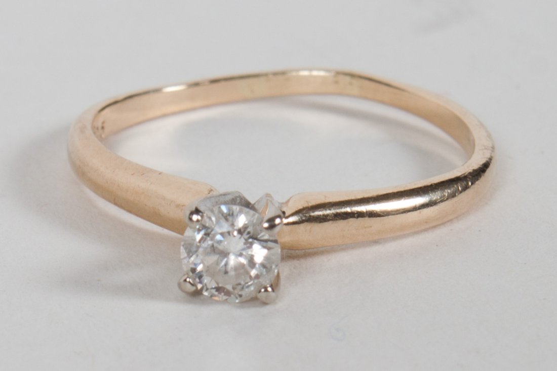 Lady's 14K gold and diamond solitaire ring: about .24 carat, size 6, 2 grams