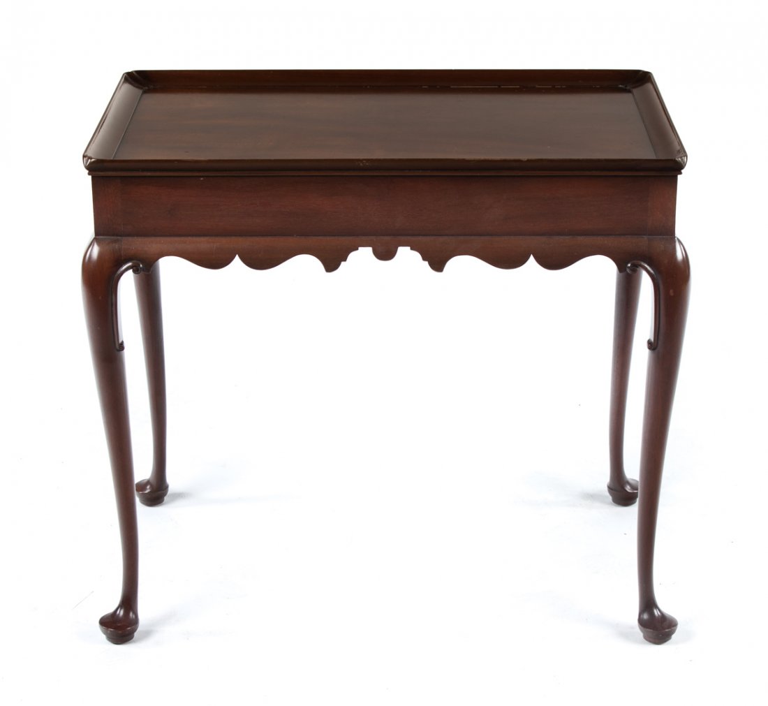 Kittinger Queen Anne style mahogany tea table: 20th century; rectangular dish top, scalloped apron, cabriole legs with pad feet, double candle slides, 26 12 in. H., 29 1/4 in. L., 17 3/4 in. D.