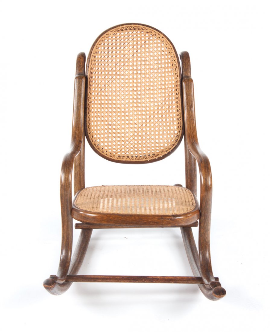 Austrian bentwood child's rocker: circa 1890; maker Fischel, Vienna, caned panel back and seat, curved back, arms, and rocker base, 26 in. H., 32 in. L., 16 in. D.