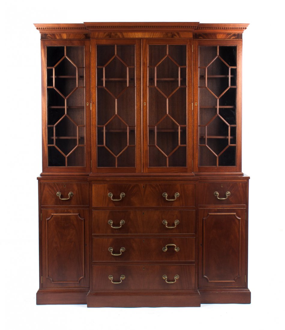 Chippendale style mahogany breakfront: Biggs, 20th century; flat top with dentil cornice, upper case has compartment with shelves enclosed by astragal glass panel doors, lower case has fitted secretary drawer with fall-front writing board,