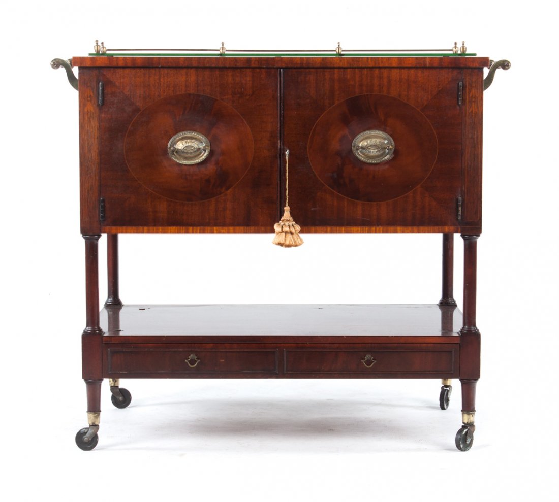 Hepplewhite style inlaid mahogany bar: 20th century; compartment fitted for bar ware, enclosed by double solid inlaid panel doors, round-turned legs connected by stretcher shelf with two short drawers, brass gallery and double side handles