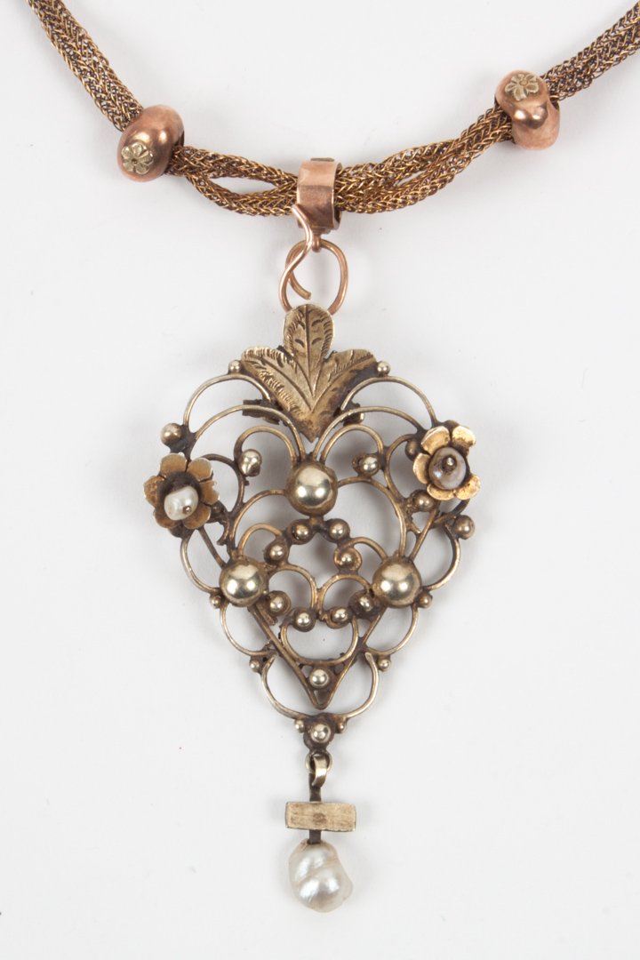 Continental lavaliere pendant and neck chain: 19th century, comprising: a baroque style openwork white gold pendant with light brown patina, enhanced with small pearls; suspended on a rose-gold herringbone ribbon, about 21 in. L.; the pendant and
