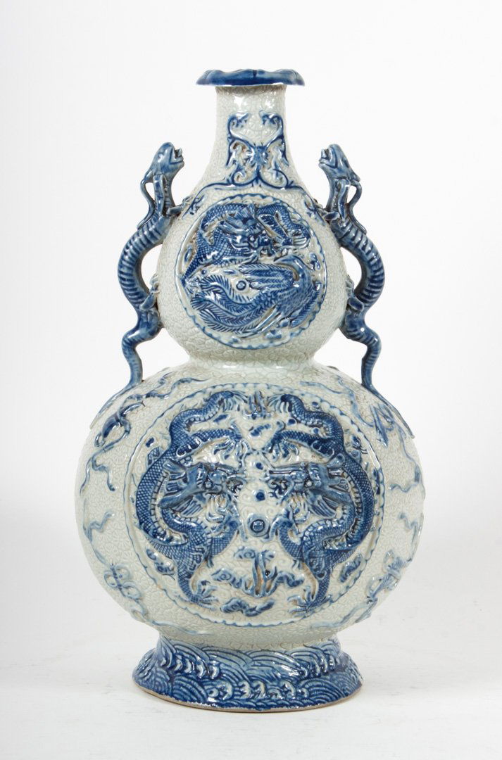 Chinese glazed stoneware double gourd vase: 20th century; dragon-form handles, four vignettes with dragon relief decoration, impressed character mark, 13 in. H.
