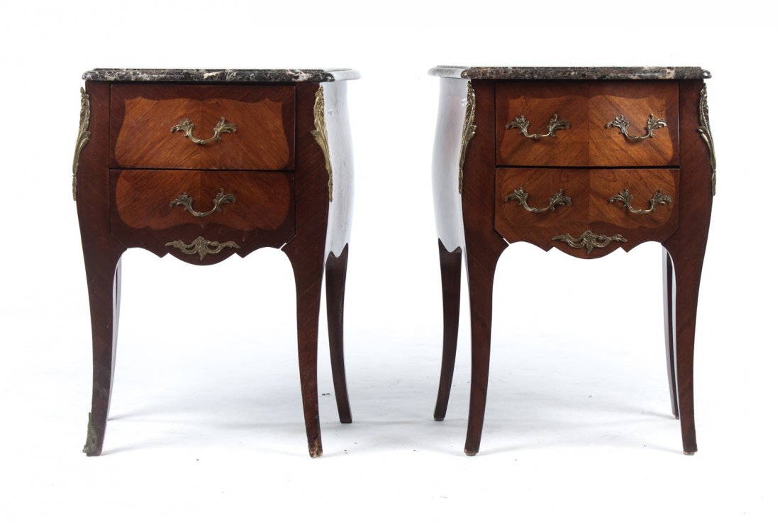 Pair of Louis XV style inlaid marble top stands: 20th century; shaped grey variegated marble tops, bombe cases with two shaped short drawers, cabriole legs, applied cast brass chutes and sabots, 27 1/2 in. H., 21 in. W., 15 in. D.