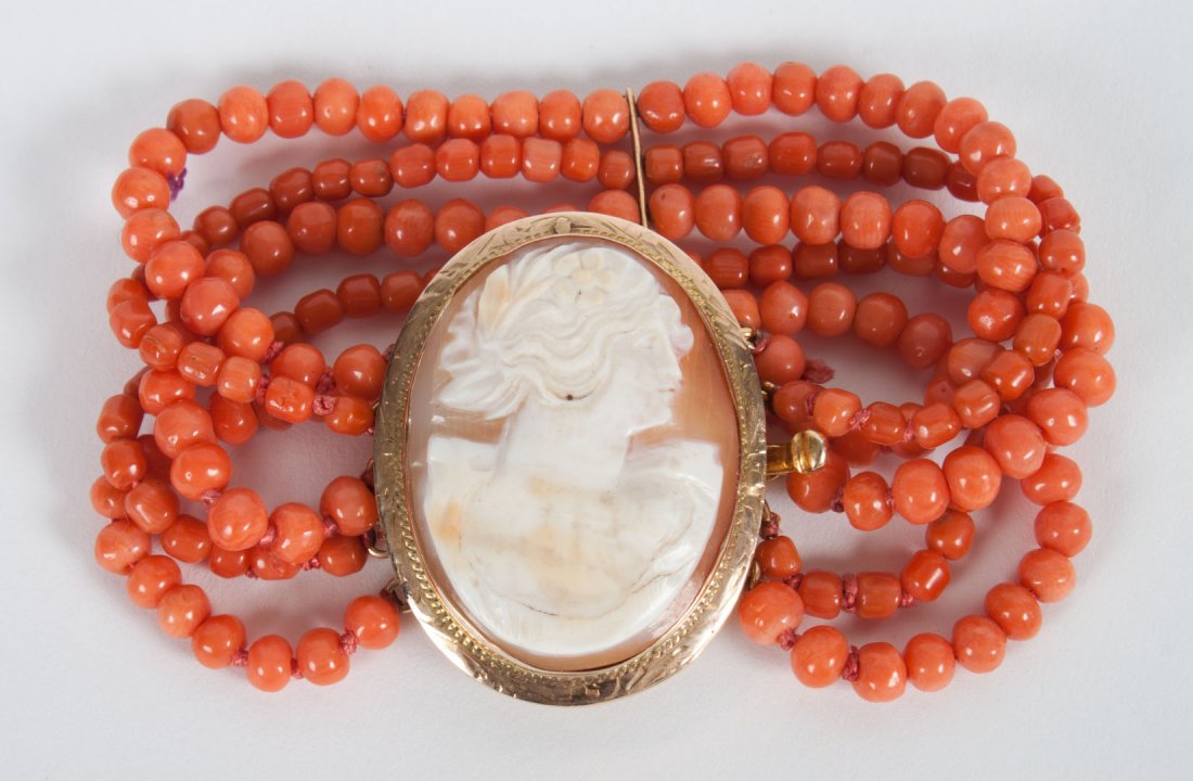Coral bead bracelet with oval shell cameo: of a young lady, set in 14K gold, clasp marked 14K, 6 1/2 in. L., 31 grams t.w.