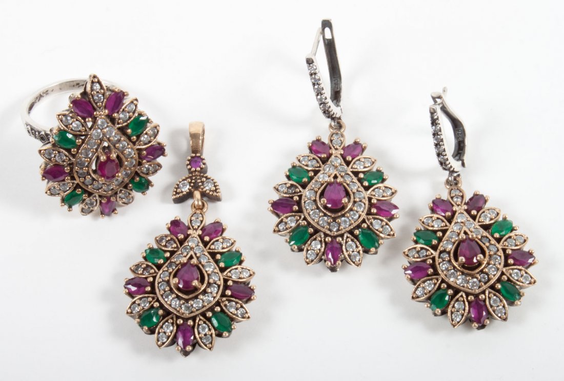 Mughal style ruby and emerald parure: pendant, ring, and earrings, set with ruby, emerald, and cubic zirconia; the metal is silver and gold vermeil