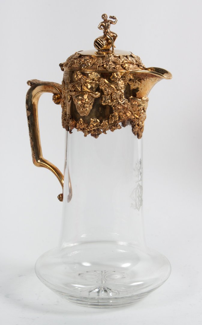 George III gilt silver & cut glass wine ewer: dated 1792-93, maker's mark rubbed, possibly E. Morley, London, hinged lid with figural knop, raised satyr mask and grape leaf decorated collar, glass ewer with etched cypher