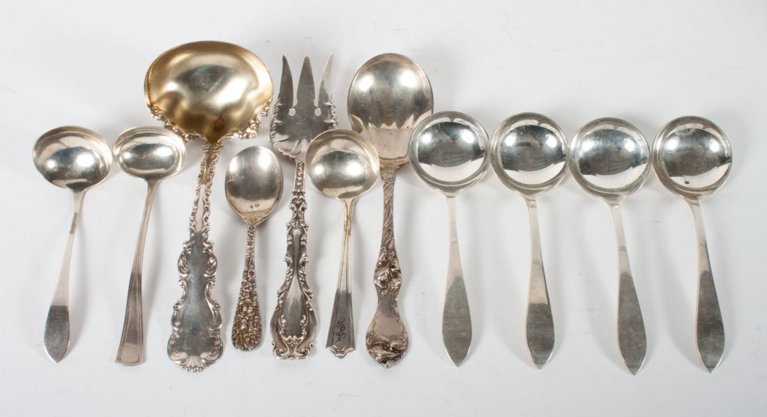 Assortment of American sterling silver flatware: including: 4 bouillon spoons, 3 sauce ladles, gravy ladle, meat fork, child's spoon, and a serving spoon, 12.15 ozt.