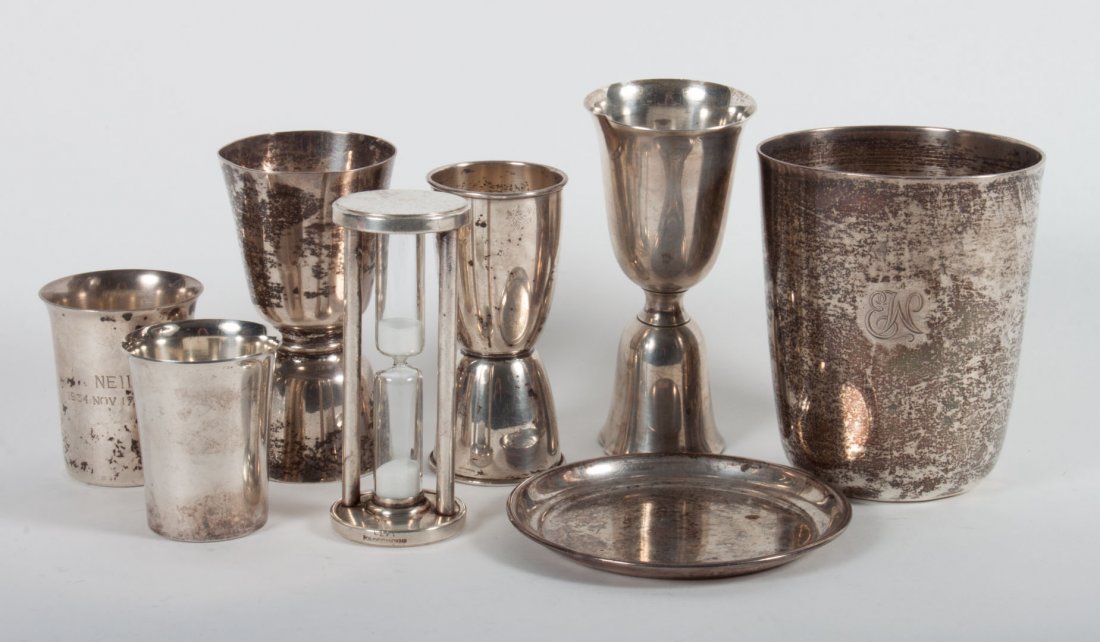 Seven American sterling silver bar accessories: including: Tiffany tumbler, three double cocktail jiggers, two cordials, and an ashtray; together with a sterling egg timer; 14.15 ozt. of weighable silver