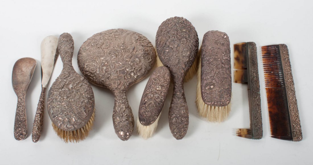 Nine Kirk or Stieff sterling mounted dresser items: including: 2 hair brushes, 2 combs (one missing teeth), 2 shoe horns (one bent), 2 garment brushes, and a hand held mirror