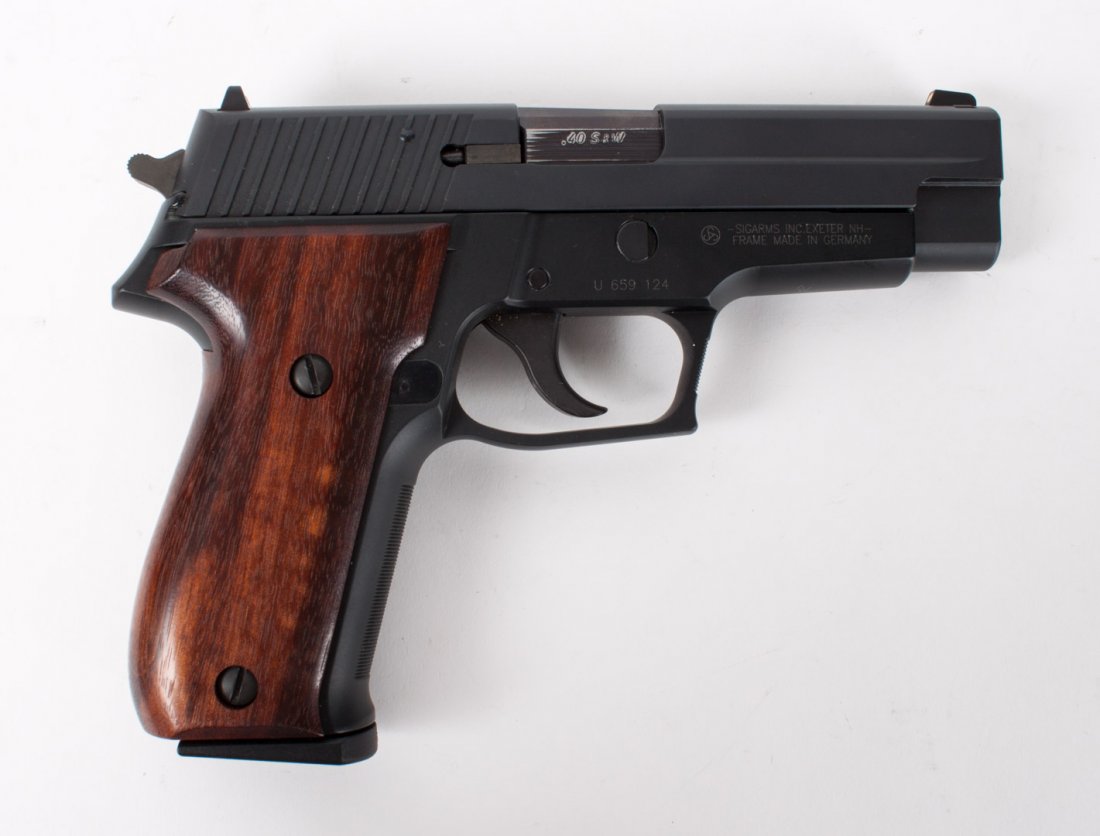 Sig Sauer P226 Stainless Semi-Automatic Pistol: serial#U659124; 40 S&W caliber; the barrel 4 1/2" long; walnut stock; 8" long overall; accompanied by 4 magazines, manual and two hard cases