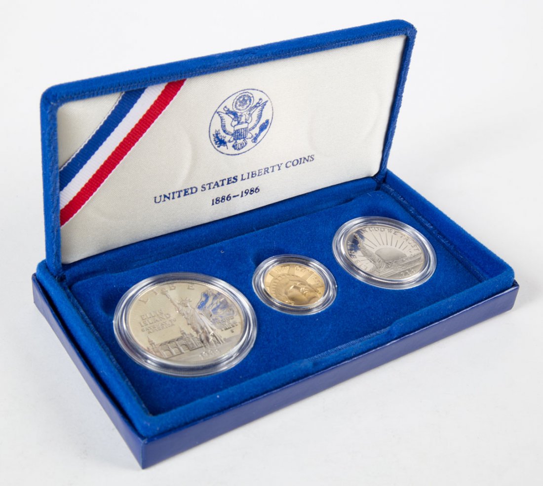 [USA] Liberty Coin Set, 1986: Comprising: a 1986s clad half dollar, a 1986s silver dollar, and a 1986w $5 gold half eagle. Grade proof 69/deep cameo. In mint box. Contains .77 OZT. silver and .25 OZT. gold.