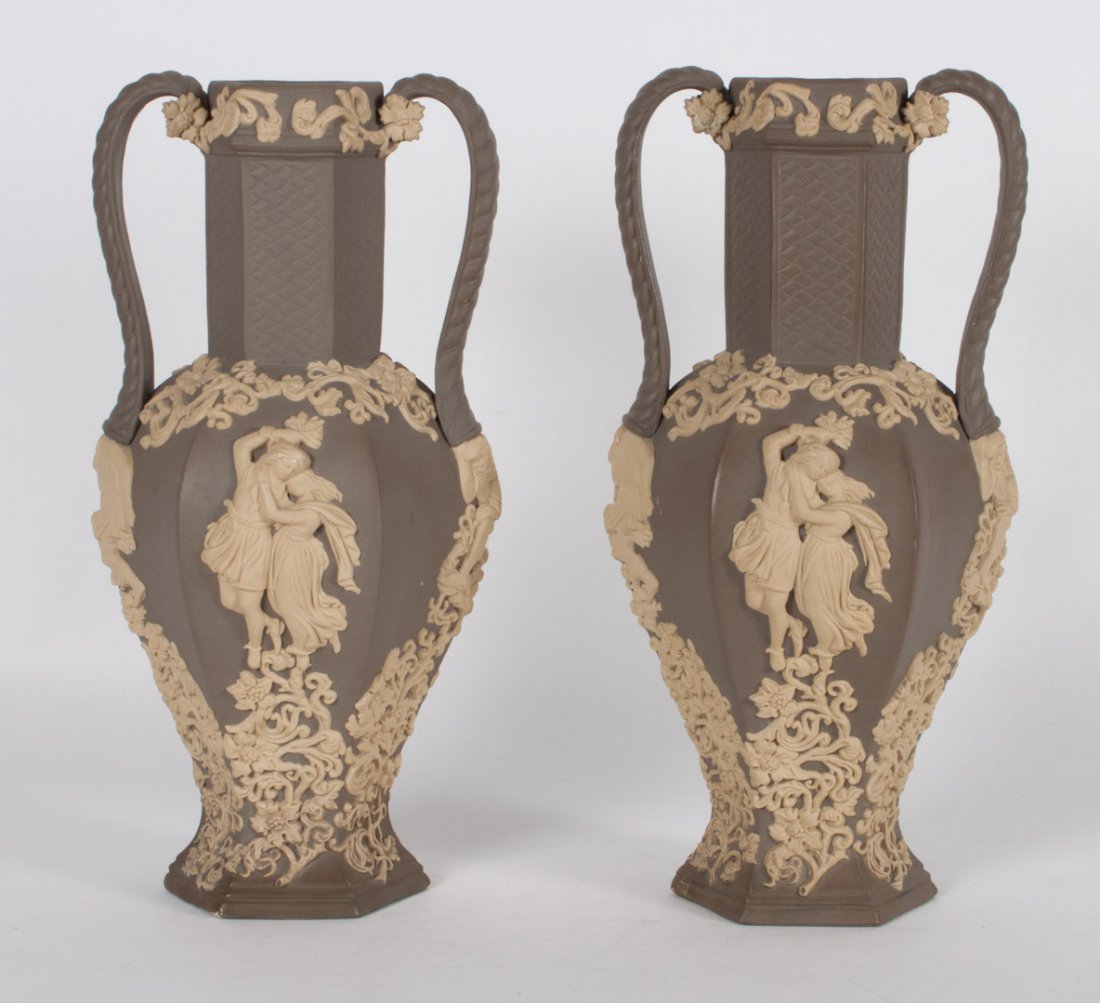 Pair of Continental jasperware vases: first half-20th century; relief decoration of happy peasants, twist handles, unmarked, 12 in. H.