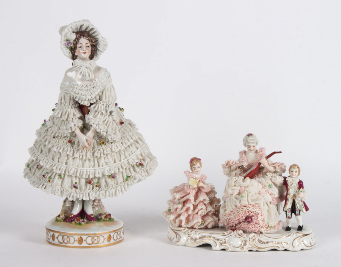 Two Dresden crinoline porcelain figures: early 20th century; figure of standing woman, with Dresden mark, 11 in. H., and a Muller & Co., family musical party, 5 1/2 in. H., 8 in. W.
