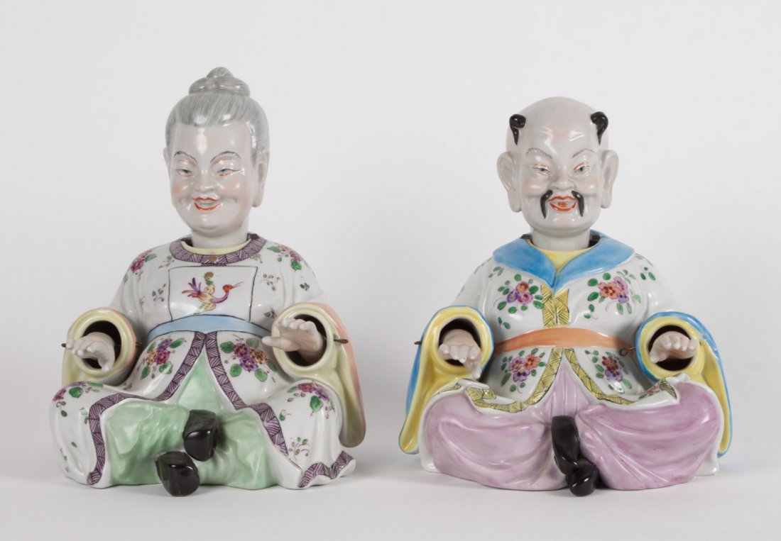 Pair of Dresden porcelain pagoda nodders: second half-20th century; mandarin and lady in elaborately painted floral decorated garments, with lead weighted nodding heads and hands, blue underglaze mark, 7 in. H.