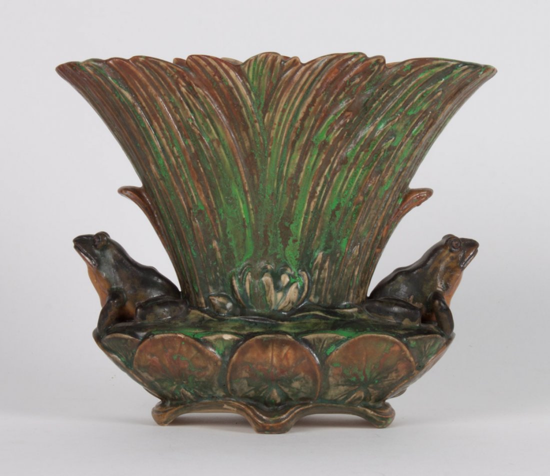 Weller art pottery planter: circa 1920s; modeled as group of cattails flanked by frog on either side, with water lilies, stamp mark, 8 in. H., 9 in. W.