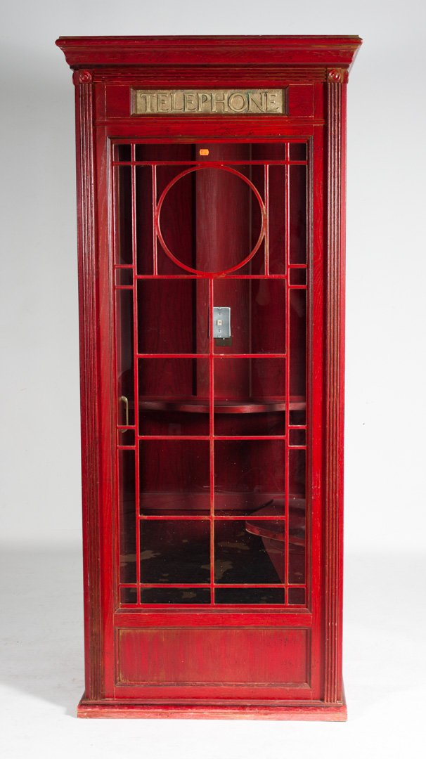 Wood and glass telephone booth: painted red wood with glass panels, telephone brass plaque, folding door with interior seat and modern phone jack and lighting, 80 in. H., 30 in. W., 34 in. D.