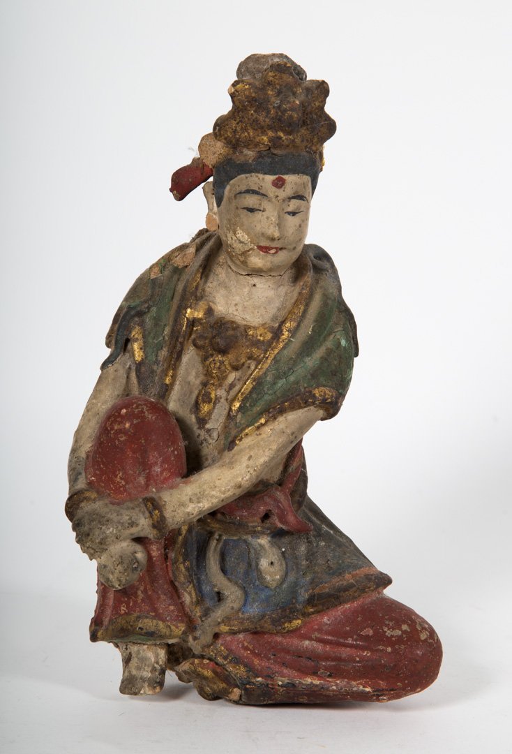 Chinese figure of a Boddhisatva, Ming: probably an architectural fragment, depicting a seated man, one leg drawn up; painted and gilt earthenware, 8 in. H.