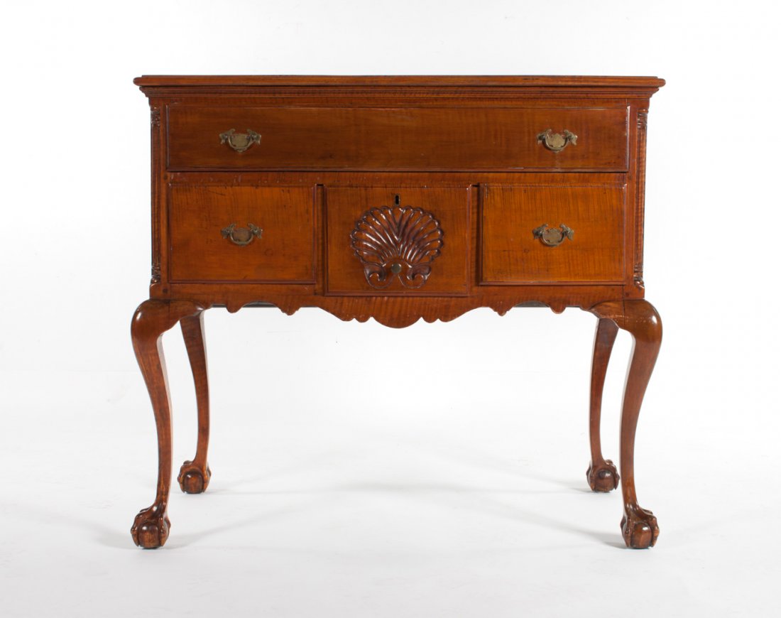American Chippendale tiger cherry lowboy: circa 1740, attributed to the Chapin Brothers., Hartford, Connecticut; flat top with molded edge, one long, two short, and one fan-carved center drawer in case, corner pilaster supports, cabriole legs