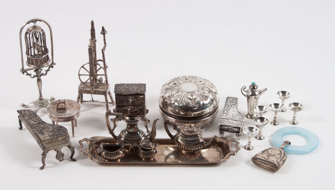 Continental silver miniature furniture items: 18 pieces, including: spinning wheel, bird cage, two pianos, sewing machine, 4-piece coffee/tea service and tray, 2-drawer chest, pitcher, and 6 goblets; together with a Gorham sterling silver cased y