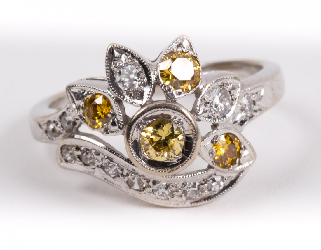 A Natural Yellow Diamond Ring: white and yellow diamonds mounted in 14K white gold