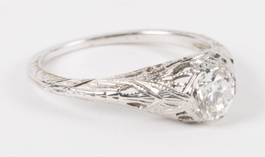 A Diamond Solitaire Filigree Ring: featuring a 0.59 carat diamond, mounted in 14K white gold