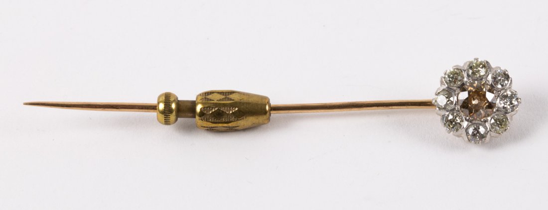 A Diamond Stick Pin: 10K gold stick pin with center colored diamond, in an old mine-cut diamond surround, approximately 1 3/4 tdw
