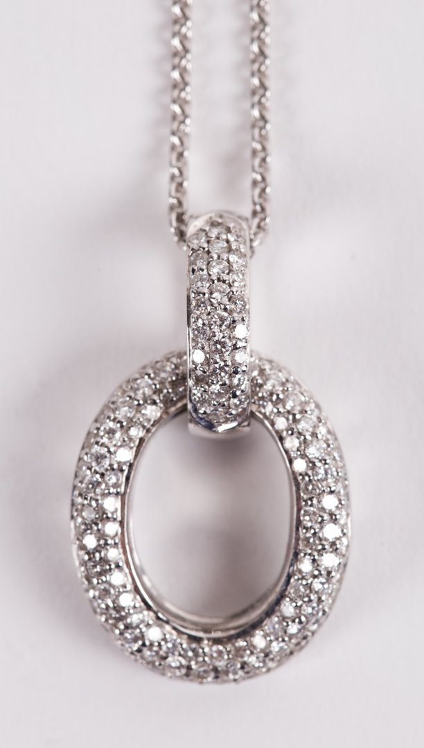 A Pave Diamond Oval Pendant Necklace: 18K white gold, with round, full-cut diamonds, approximately .57 tcw, pendant is signed with indistinguishable maker's mark, chain 19"L