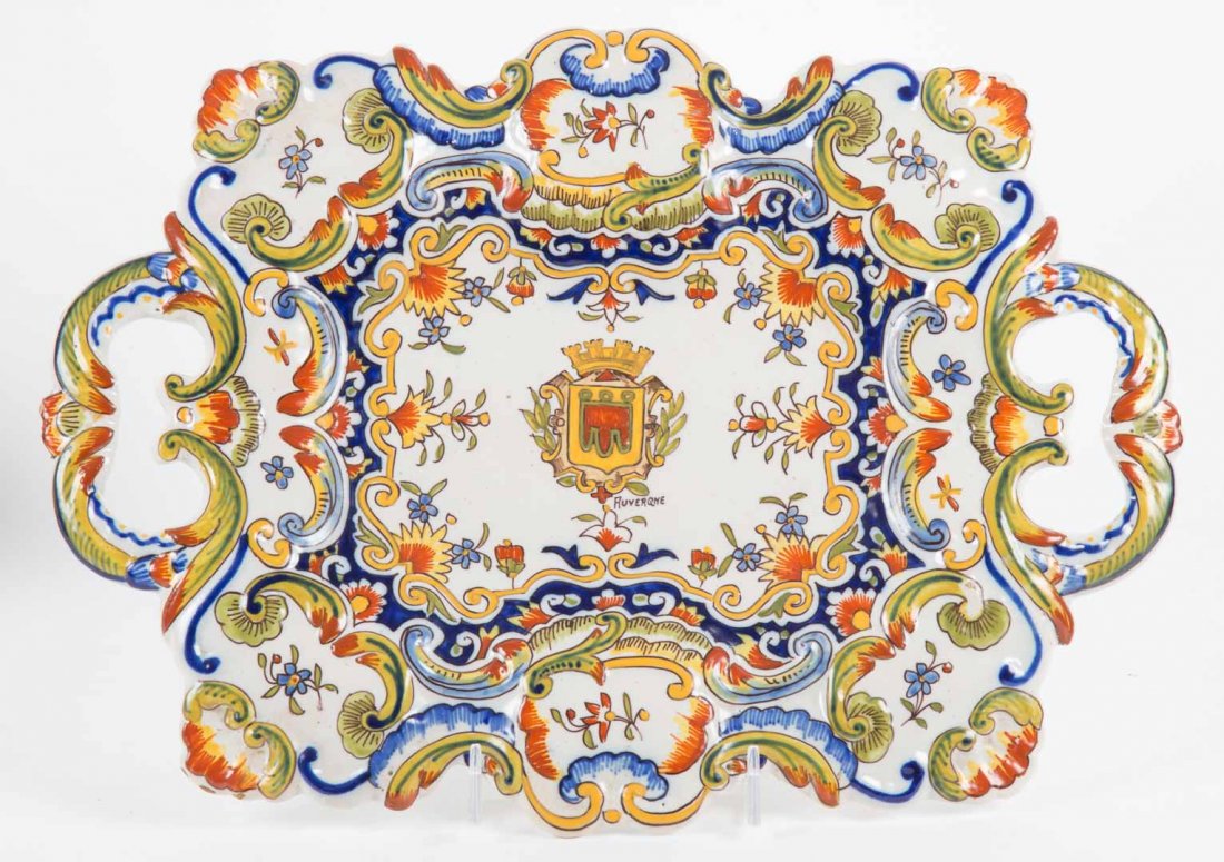 Auvergne faience two-handled shaped tray: 20th century; heraldic and floral decoration, 13 in. L., 10 in. W.
