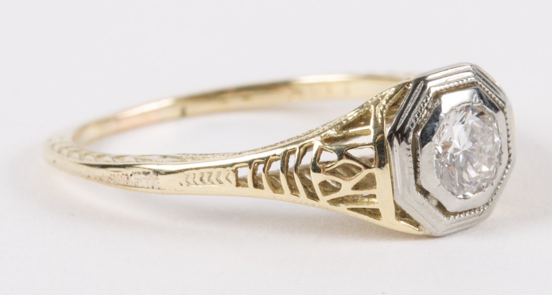 A Yellow Diamond Solitaire Filigree Ring: featuring a 0.30 carat diamond, mounted in 14K gold