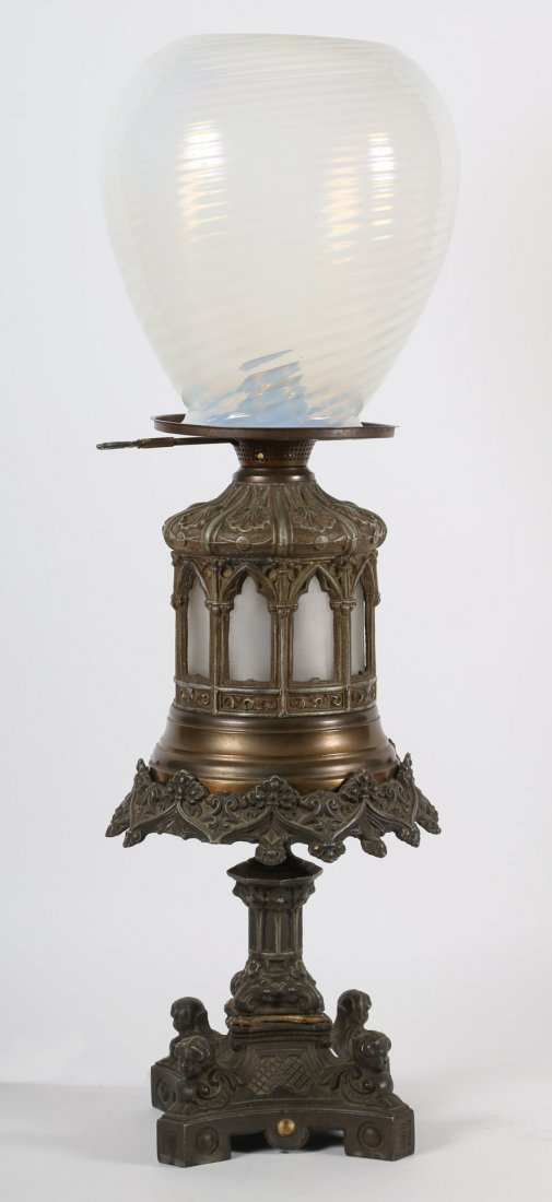 Gothic influenced cast metal oil lamp: late 19th century; with Gothic arches with frosted glass interior and associated opalescent swirl glass shade, 23 in. H.