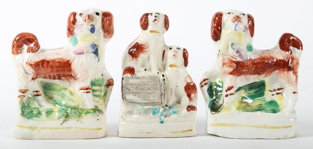 Three Staffordshire earthenware dogs: second half-19th century; pair of dogs, each with duck in mouth, 4 in. H., and pair of dogs of barrel, 4 in. H.