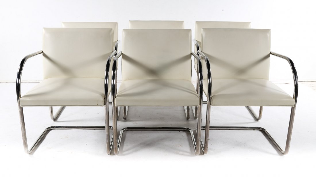 Six Mid-Century Modern style tubular steel chairs: designed by Mies van der Rohe, manufactured by Knoll, white leatherette upholstered backs and seats, steel frames, 32 in. H., 23 in. W., 20 in. D.