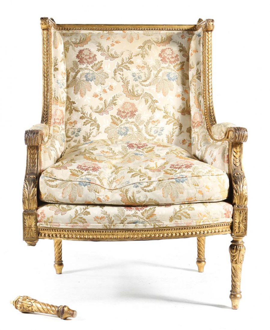 Louis XVI style carved giltwood bergere: exposed guilloche carved frame, floral silk upholstered back, arms, and loose seat cushion, foliate carved and twist turned legs, 40 1/2 in. H., 26 in. W., 25 1/2 in. D.