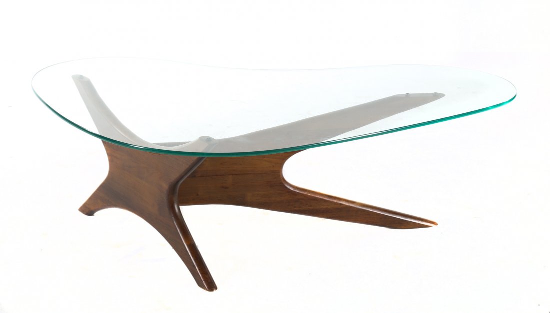 Adrian Pearsol walnut and glass coffee table: walnut abstract-form base with shaped glass top, 16 in. H., 51 in. W.