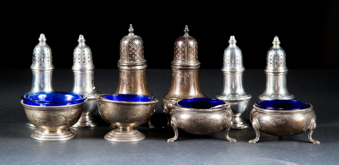 Assorted American sterling shakers and salts: comprising: four standing peppers, pair of trencher salt cellars (one bent) with cobalt liners, and a pair of standing peppers and matching salts with cobalt liners; together with a sterling and Germa