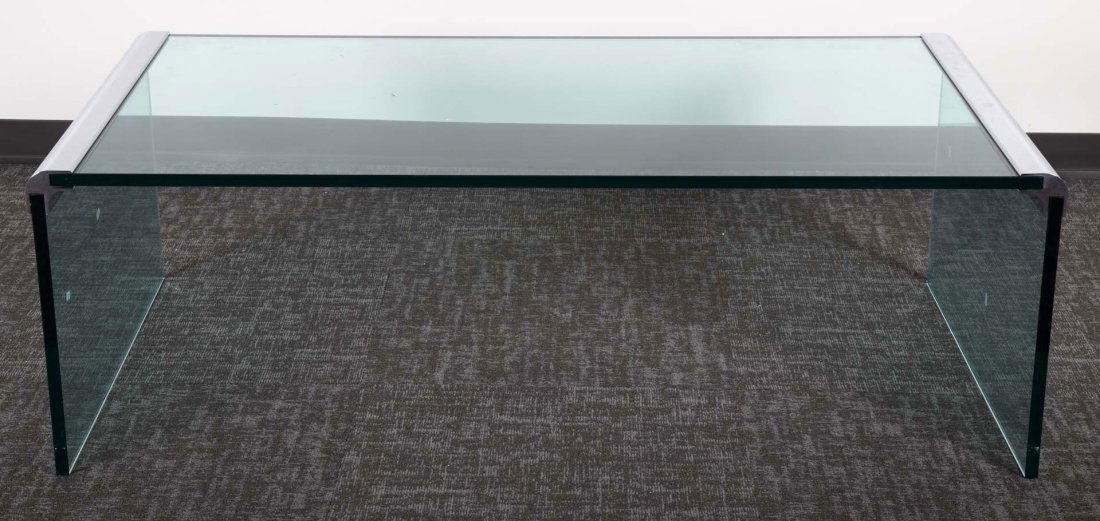 Brueton glass and steel coffee table: smoked glass and polished steel coffee table, 18 in.H., 57 in. L. 27 in. W.