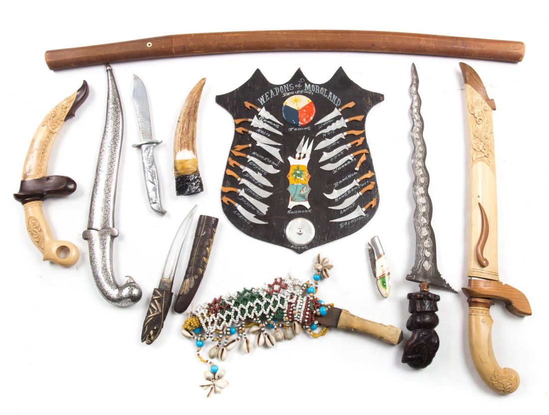 Assortment of Asian daggers, knives, and a sword: one silver metal dagger, iron fish dagger, one beaded bone handled dagger, horn obsidian dagger (as is), one enamel pocket knife, one wood Thai handled sword, and three wooden cased knives