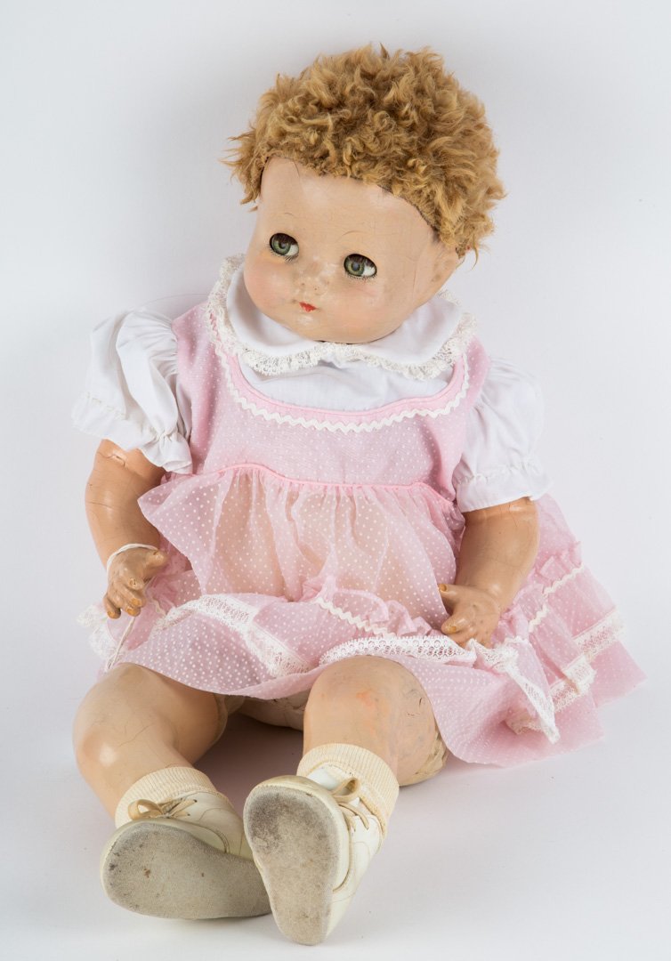 Effanbee composition and cloth baby doll: circa 1930s; composition head, arms and legs with cloth body, in pink sundress, 24 in. L.