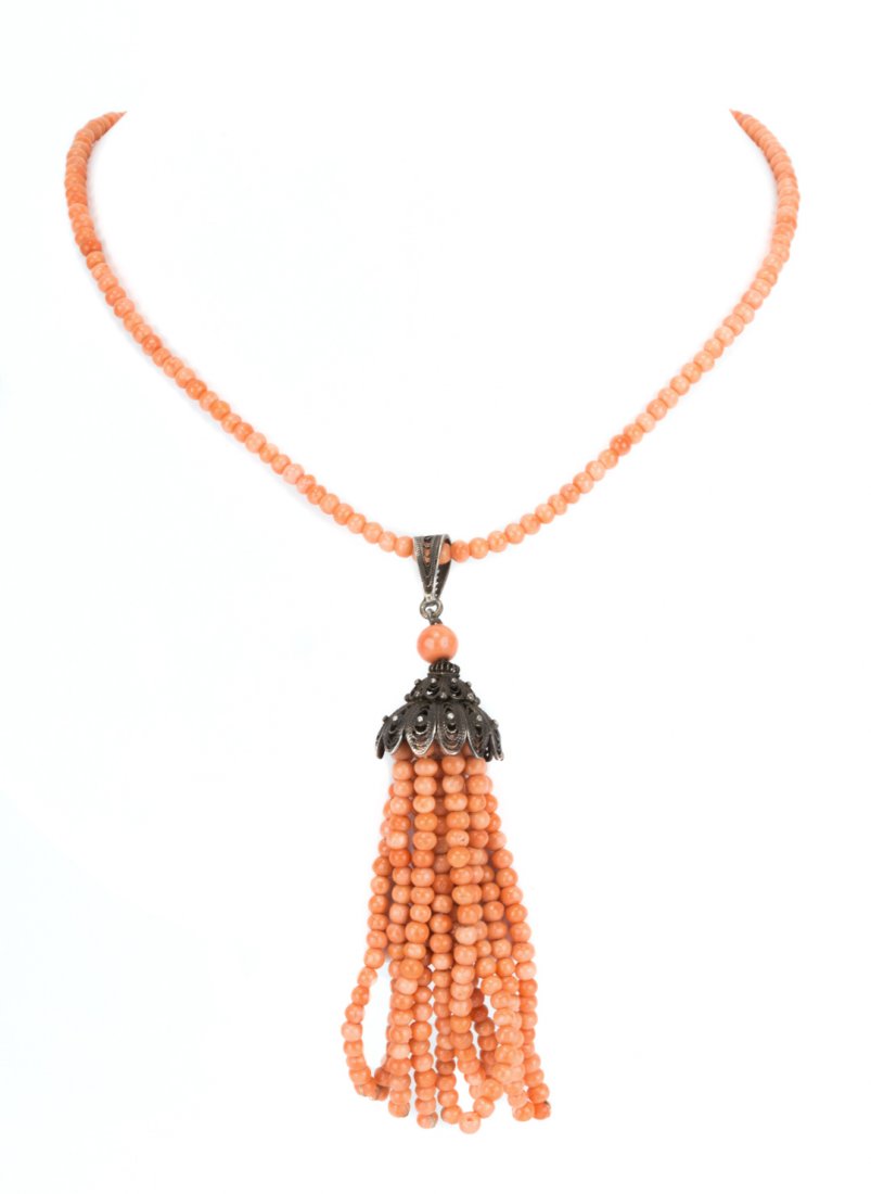 A Victorian Coral Tassel Necklace: Round well matched coral beads measuring 4mm designed in tassel necklace style necklace with silver fishhook clasp, 21 in. L