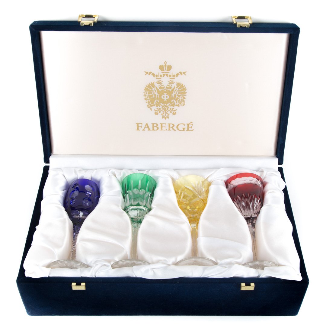 Four Faberge color cut to clear glass stems: emerald, cobalt, ruby and amber cut to clear wine stems, with acid etched mark, in a blue velvet presentation box with Faberge coat of arms on lid, stems-6 in. H.
