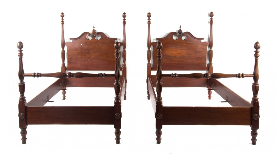 Pair of Potthast mahogany beds: 20th century; acorn finials with broken pediment headboards, matching footboards, 59 in. H., 43 1/2 in. W.