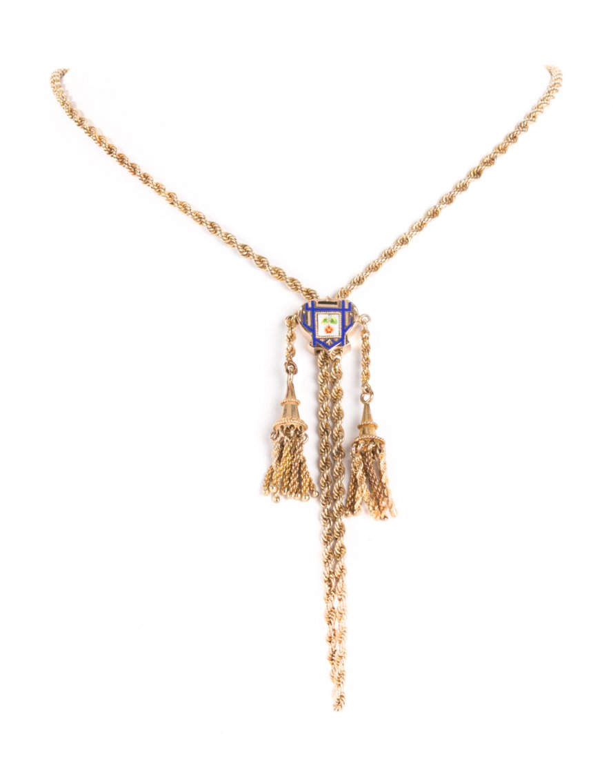 A Victorian Slider on Rope Chain: 14K yellow gold rope chain, with tassel accents and a blue enamel slider, 40 in L, 40 grams tw